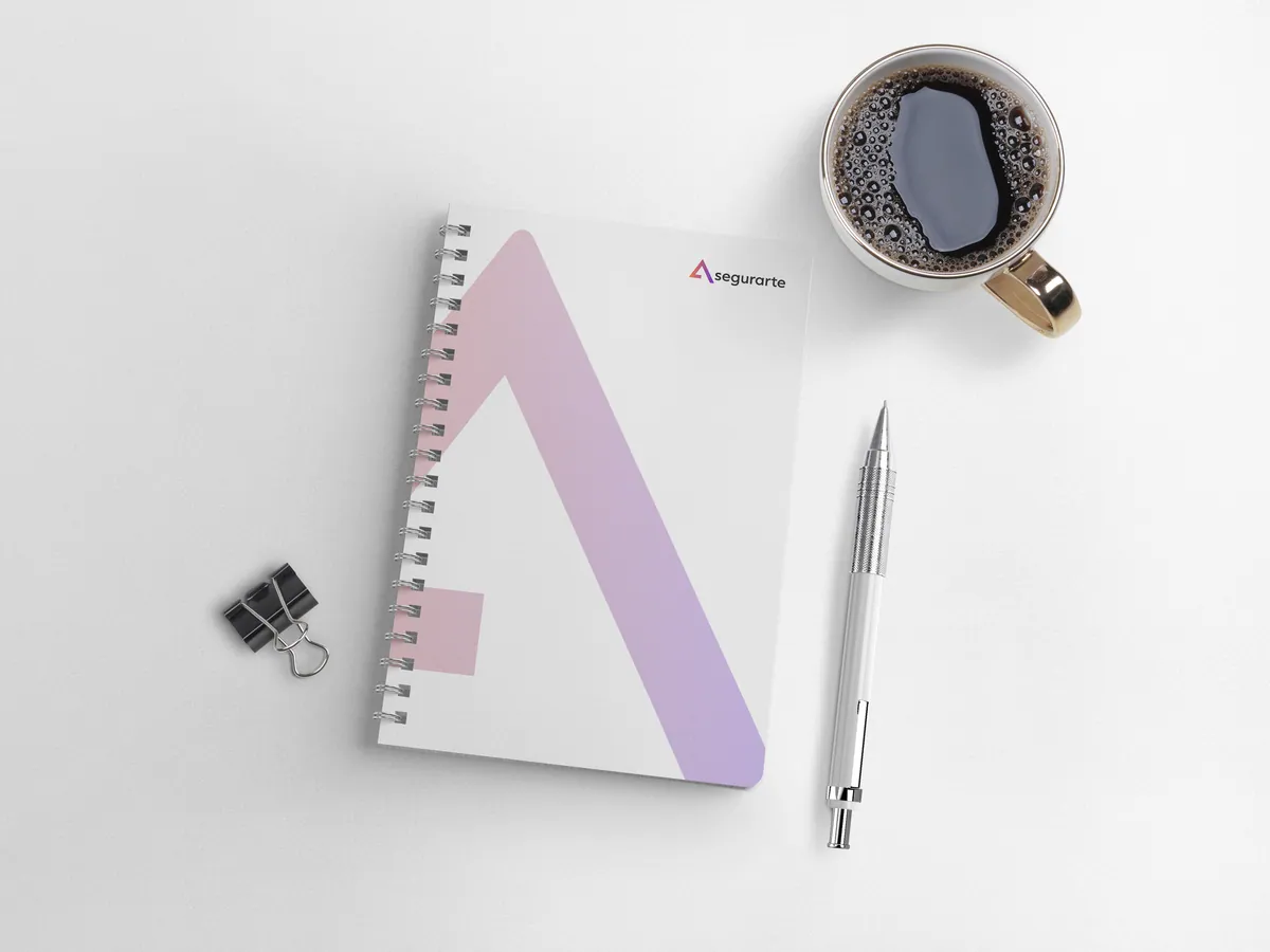 Spiral notebook with the Asegurarte mark.